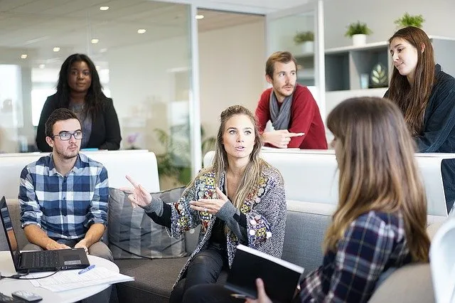 Team in a meeting room talking during a training session